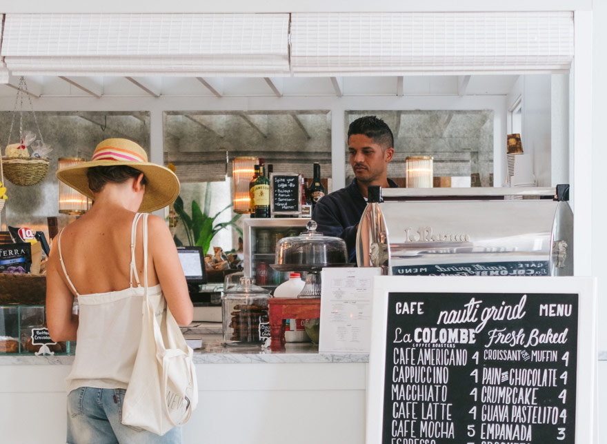 Customer and employee at counter of restaurant