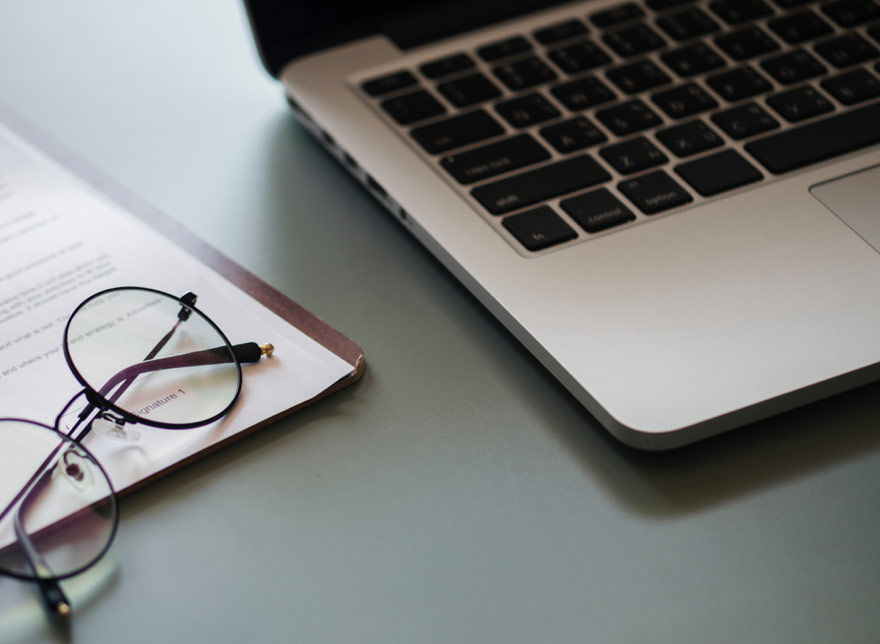 Glasses next to laptop